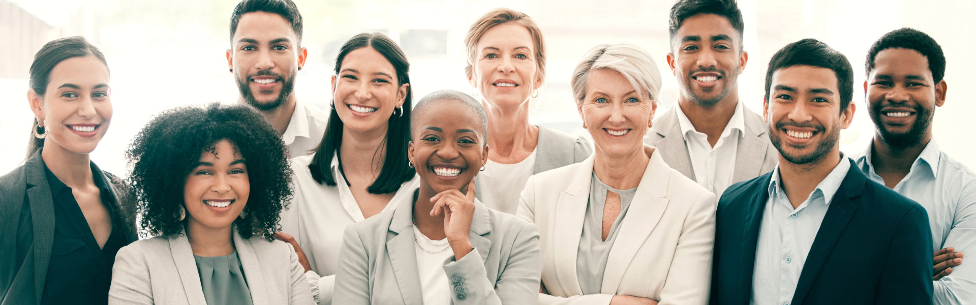 Smiling Colleagues Standing in an Office with Natural Light