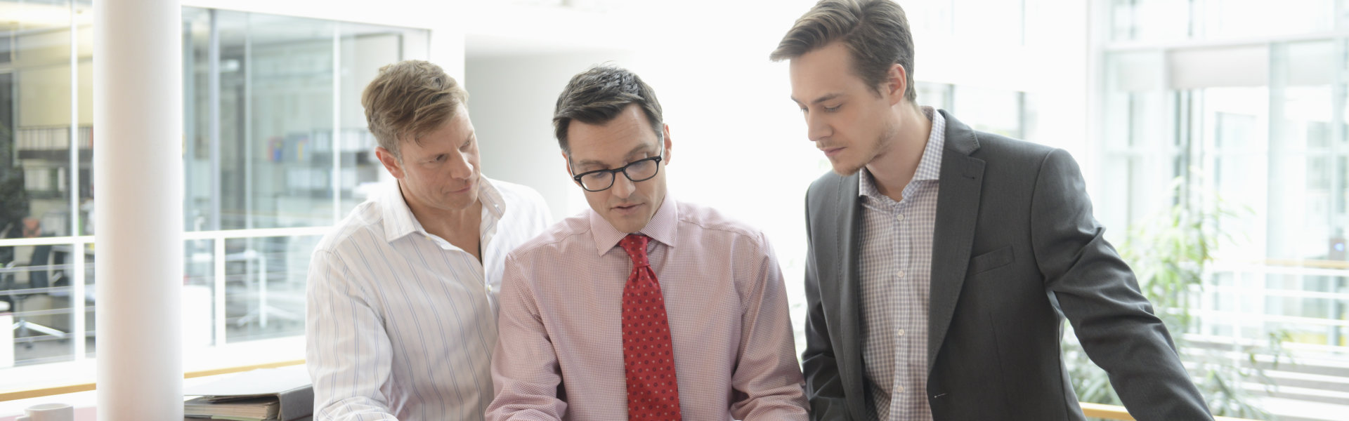 three person having discussion